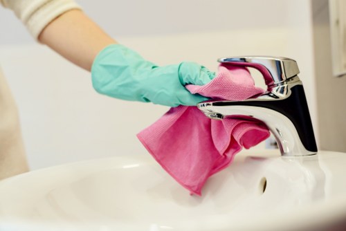 Professional office cleaners working in a Maidavale business workspace
